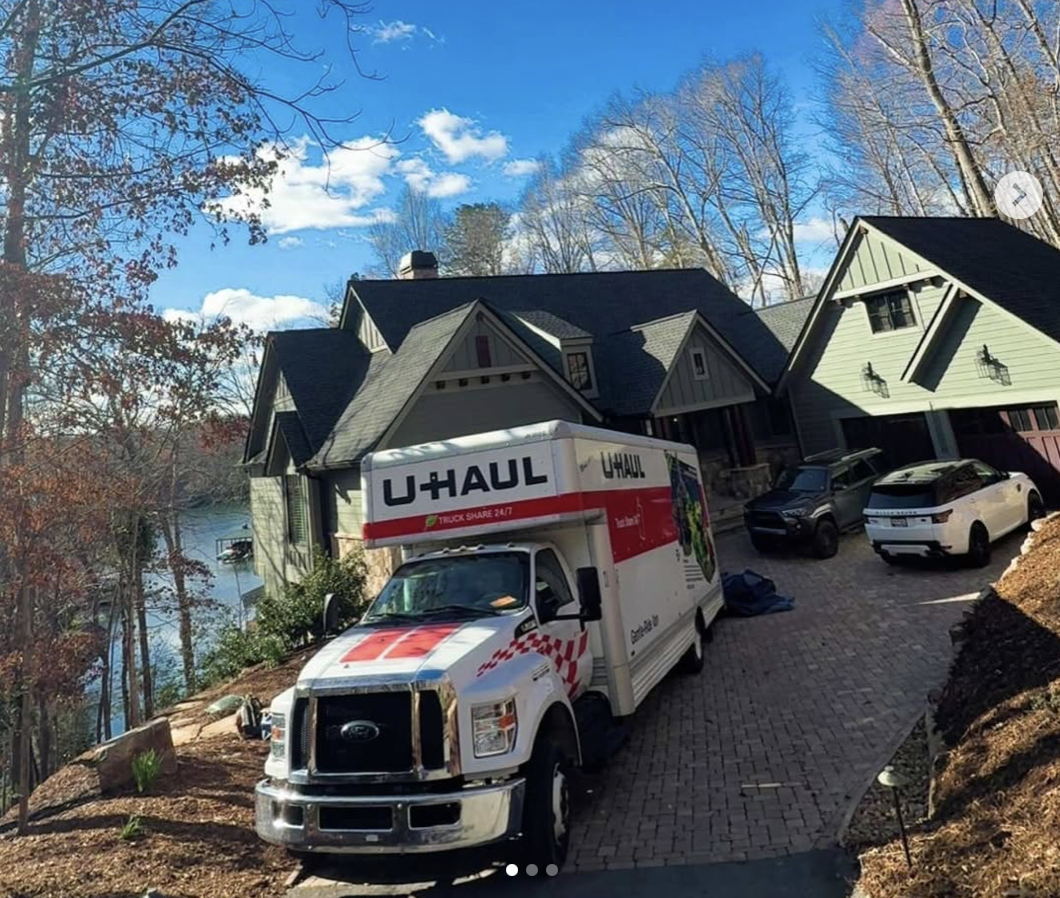 Southern Charm Moving U-Haul truck parked at a lakeside Upstate SC home on moving day