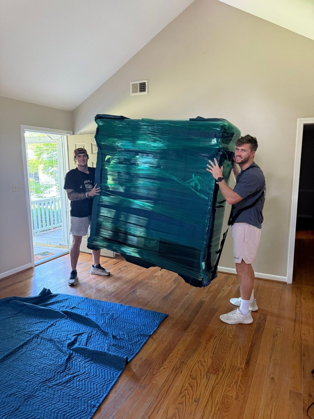 Southern Charm mover carrying a sofa up an interior staircase