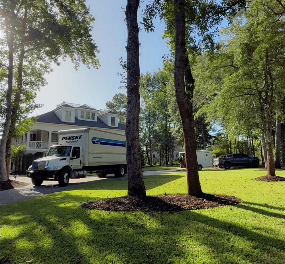 Southern Charm moving truck parked at a Southern colonial home